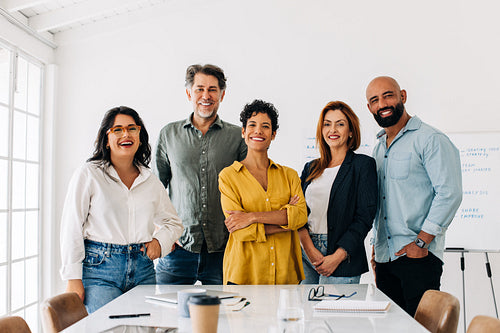 Successful business team standing together in a boardroom
