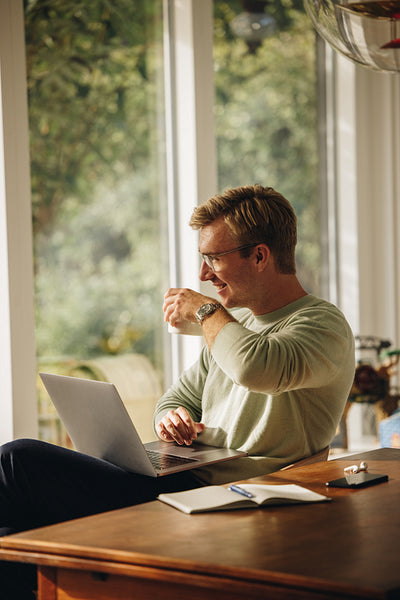 Man with laptop having coffee