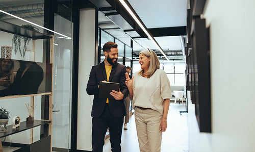 Diverse businesspeople laughing during a discussion