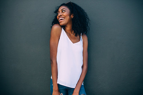 Portrait of a woman standing against a wall