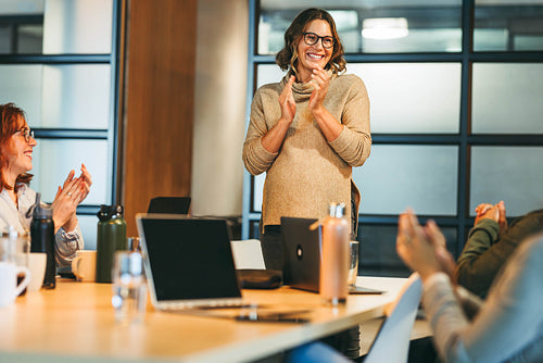 Successful business team applauds achievement in a tech company meeting