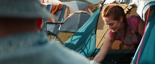 Young woman drinking and having fun with friends at a festival