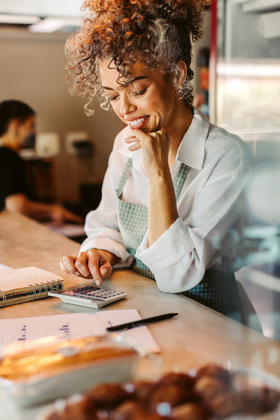 Successful business owner calculating her monthly expenses