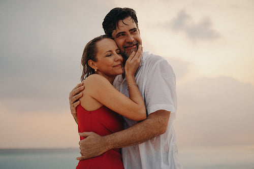 Sunset serenade: Happy mature couple embracing in love and retirement bliss