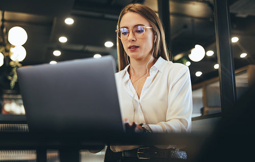 Woman working on a laptop in a modern workspace