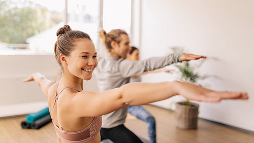 Woman practicing yoga at gym class