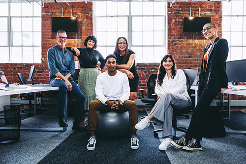 Happy team of businesspeople smiling in a modern office