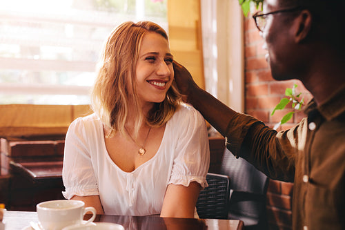 Interracial couple sitting at coffee shop