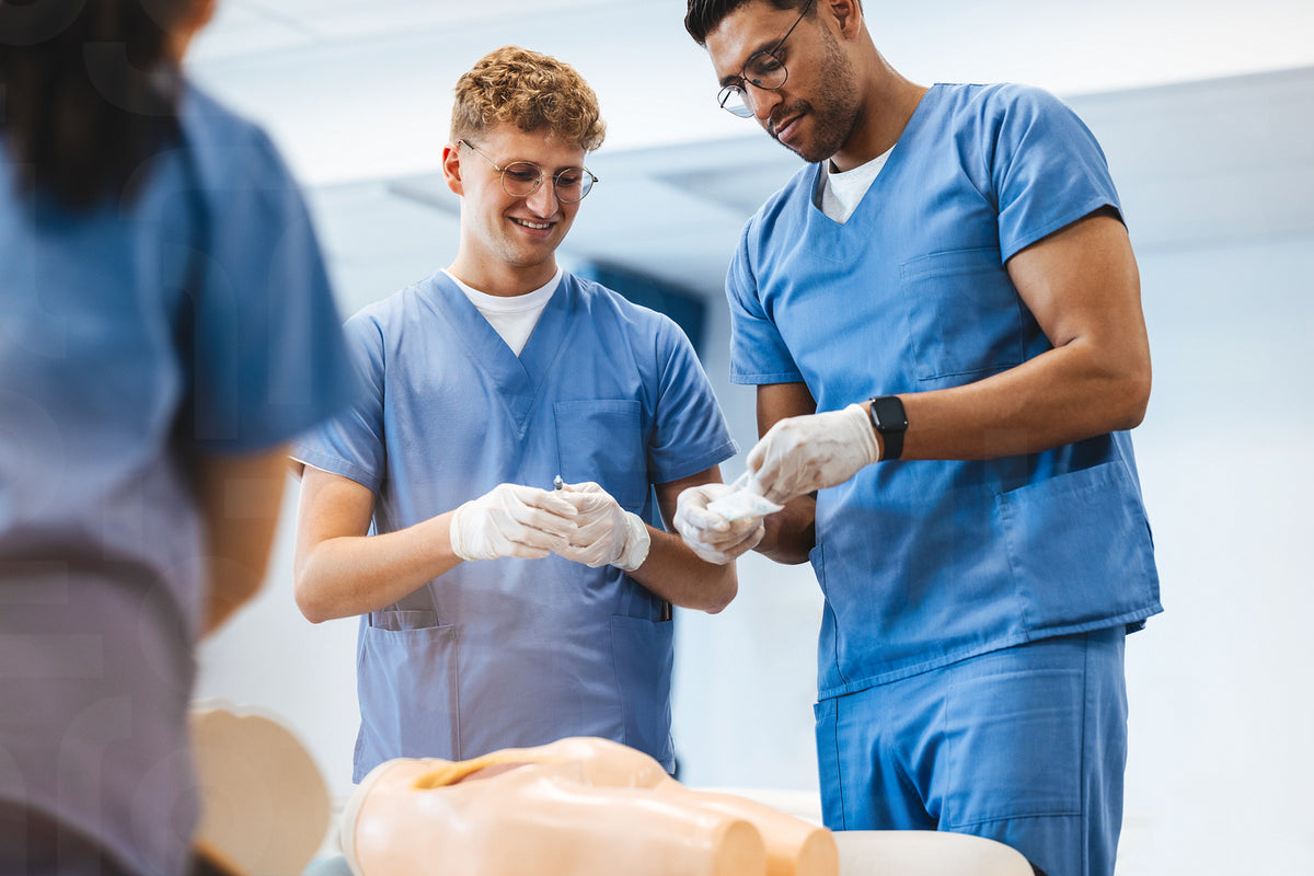 Male nursing students learn and practice how to give an injection in n ...