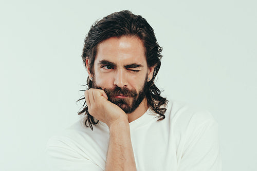 Lifestyle of grooming: Handsome young man winks in a studio