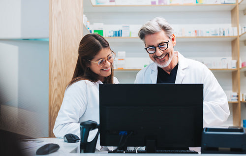 Happy pharmacists video calling a patient in a chemist