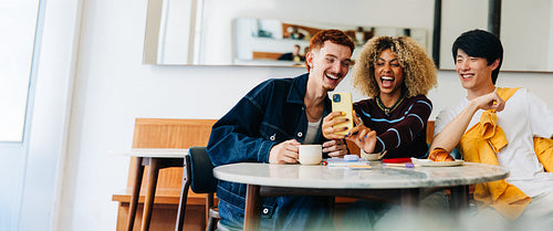 Friends laughing together while taking a selfie