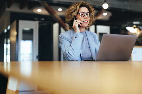 Calling clients on a mobile phone. Professional business woman talking on a phone call