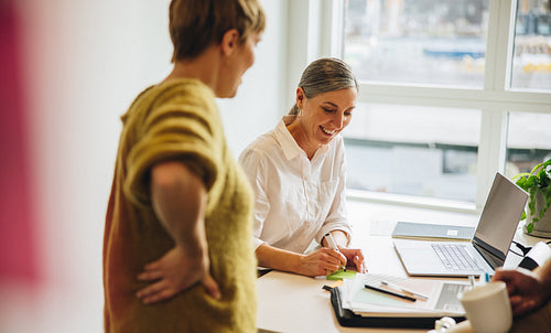 Two business woman discussing new strategy in meeting
