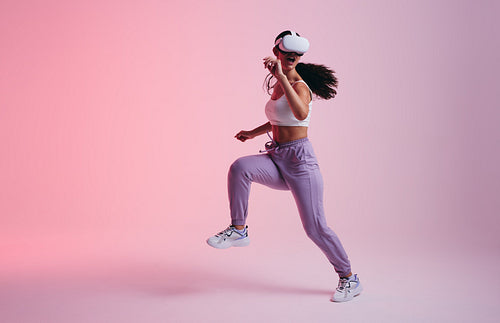 Young woman dancing in virtual reality