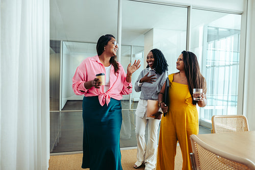 Successful team meeting during a coffee break with three women chatting