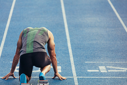 Sprinter on his marks on a running track