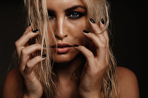 Sexy young woman on black background