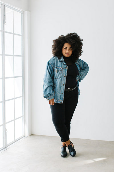 Stylish woman model posing in empty room