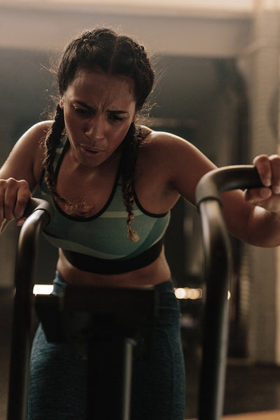 Female doing intense workout on exercise bike