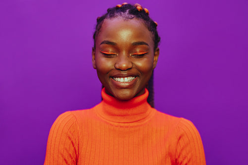 Stylish smiling woman with purple background