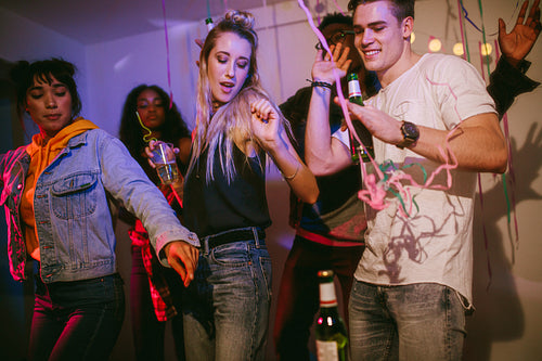 Friends dancing at a house party