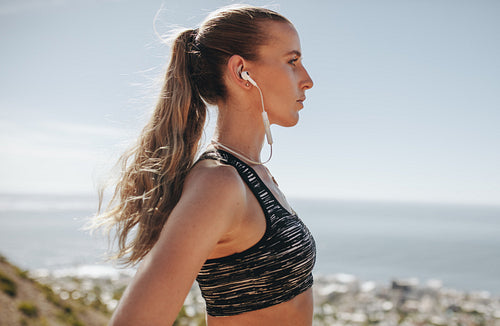Female trail runner with earphones