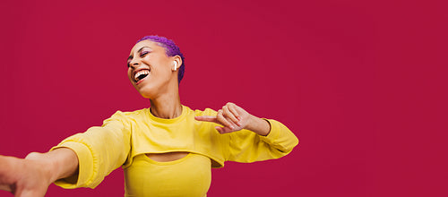 Energetic young woman dancing to her favourite song