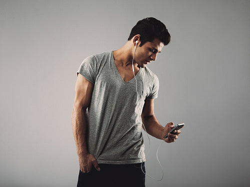 Handsome young man listening music on cell phone