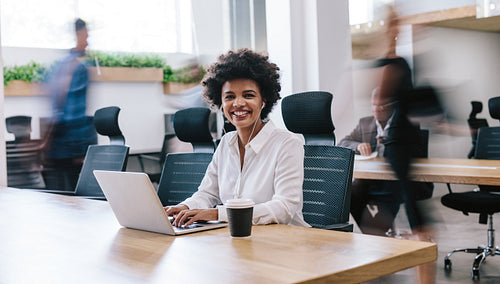 Happy businesswoman working in office