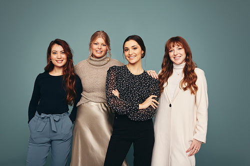 Smiling group of women standing in a studio