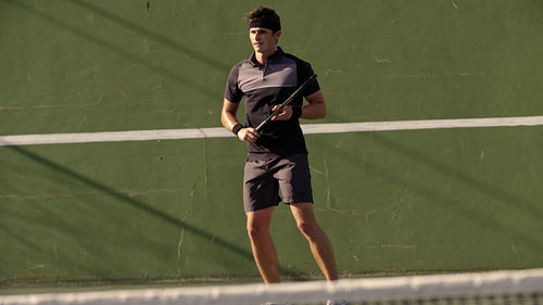 Tennis player hitting forehands on hard court
