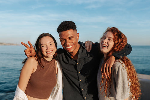 Diverse friends smiling and embracing each other