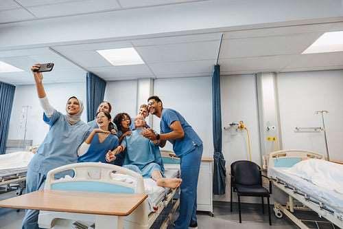 Medical students celebrate their training with a selfie in a hospital