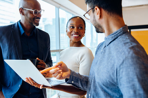 Group of colleagues engaged in discussion in a professional setting