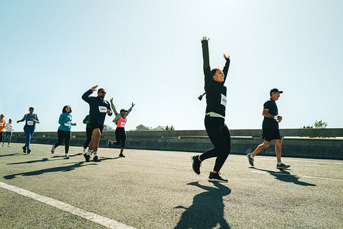 Group of runners celebrating achievement during a race