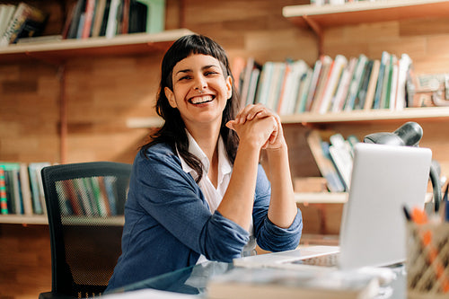 Successful businesswoman smiling in her office