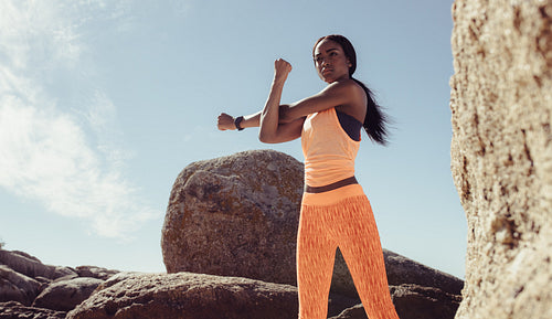 Fitness woman doing war-up exercise at the beach