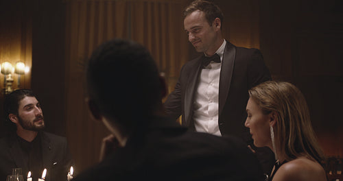 Friends celebrating with drinks at dinner party