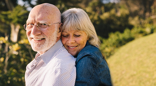 Happy mature couple embracing each other in a park