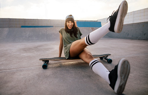 Female skateboarder having fun at skate park