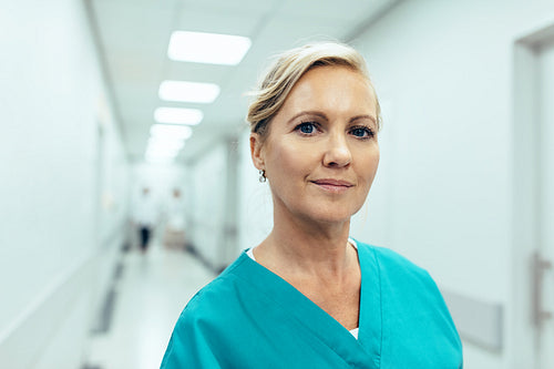 Female healthcare worker standing in hospital corridor