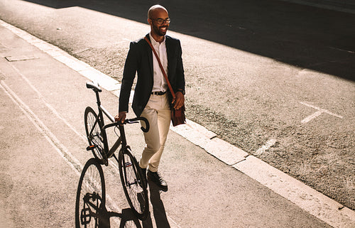 African businessman going office with his bike