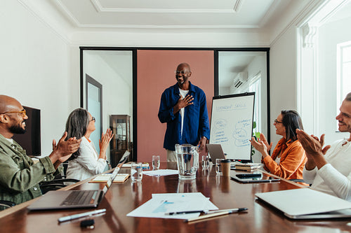 Black man leading a diverse team in a creative meeting, showcasing leadership skills