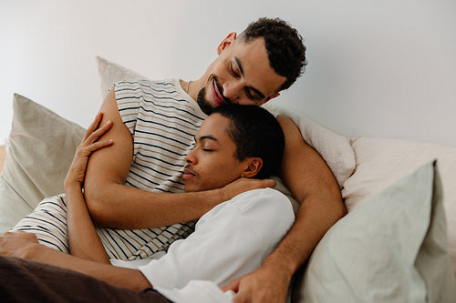 Couple embracing on a sofa in a peaceful, intimate domestic setting