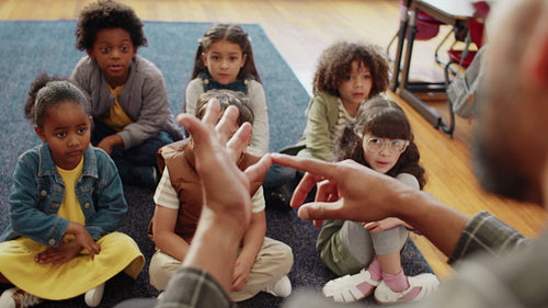 First grade teacher teaching a group of kids the alphabet using a nursery rhyme