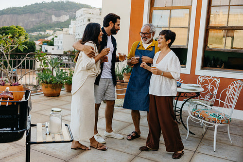 Outdoor family barbecue gathering with diverse group of smiling people in Brazil