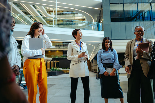 Corporate team in a lively office lobby meeting