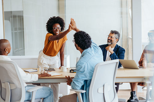 Successful business team celebrating a project in a boardroom