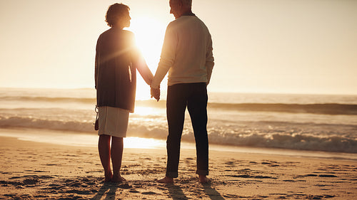 Senior couple spending some time on the beach at sunset
